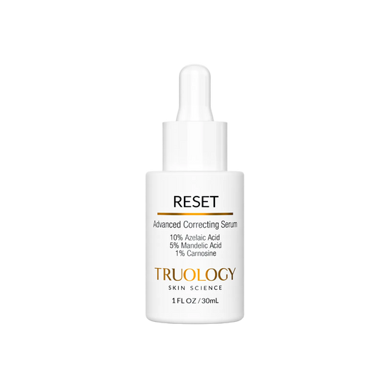 A white dropper bottle of TRUOLOGY Skin Science Reset Advanced Correcting Serum, featuring a clean white label with black and gold text, set against a solid white background.