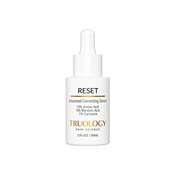 A white dropper bottle of TRUOLOGY Skin Science Reset Advanced Correcting Serum, featuring a clean white label with black and gold text, set against a solid white background.
