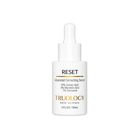 A white dropper bottle of TRUOLOGY Skin Science Reset Advanced Correcting Serum, featuring a clean white label with black and gold text, set against a solid white background.